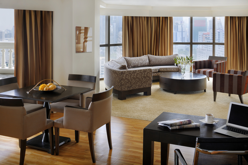 Living room wide windows, brown couch coffee table dinning table