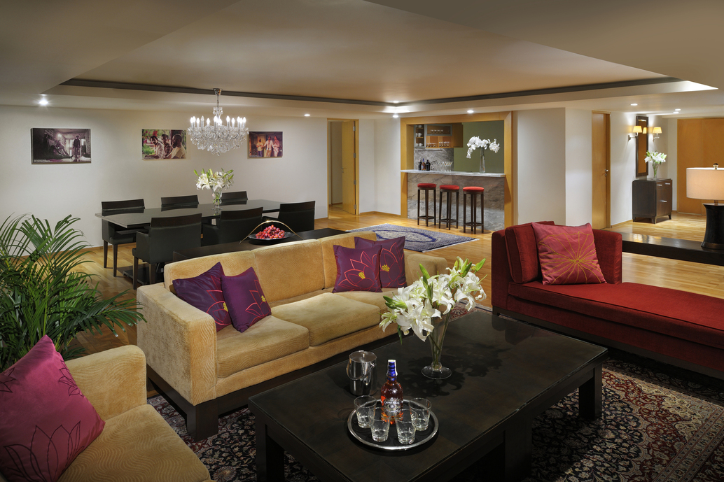 furniture red couch coffee table with flowers stools in the background