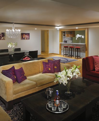 furniture red couch coffee table with flowers stools in the background