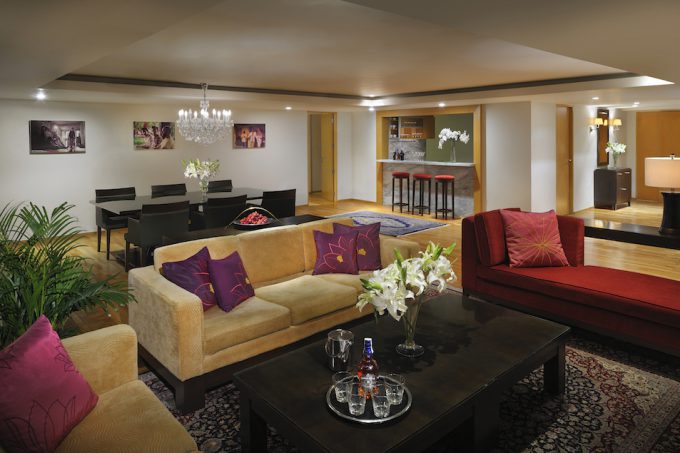furniture red couch coffee table with flowers stools in the background